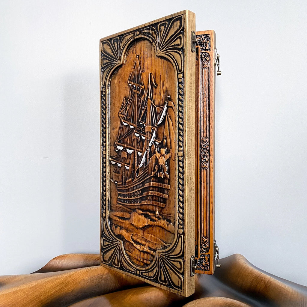 Vintage carved wood backgammon set featuring an ornate tall ship motif on the front panel.