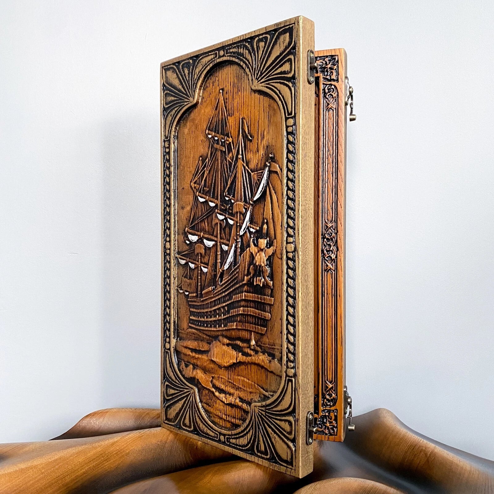 Vintage carved wood backgammon set featuring an ornate tall ship motif on the front panel.