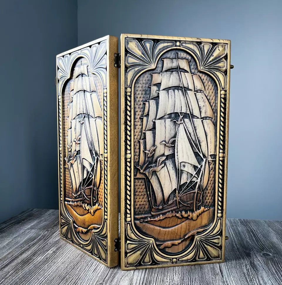 Handcrafted wooden backgammon set with detailed sailing ship engraving on the exterior.