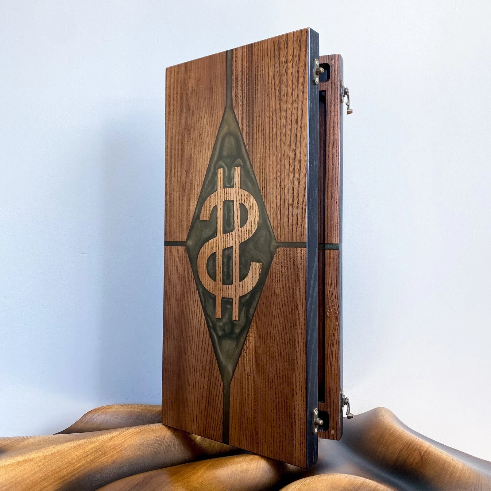 Handmade ash wood backgammon case showcasing a dollar sign design with green resin accents.
