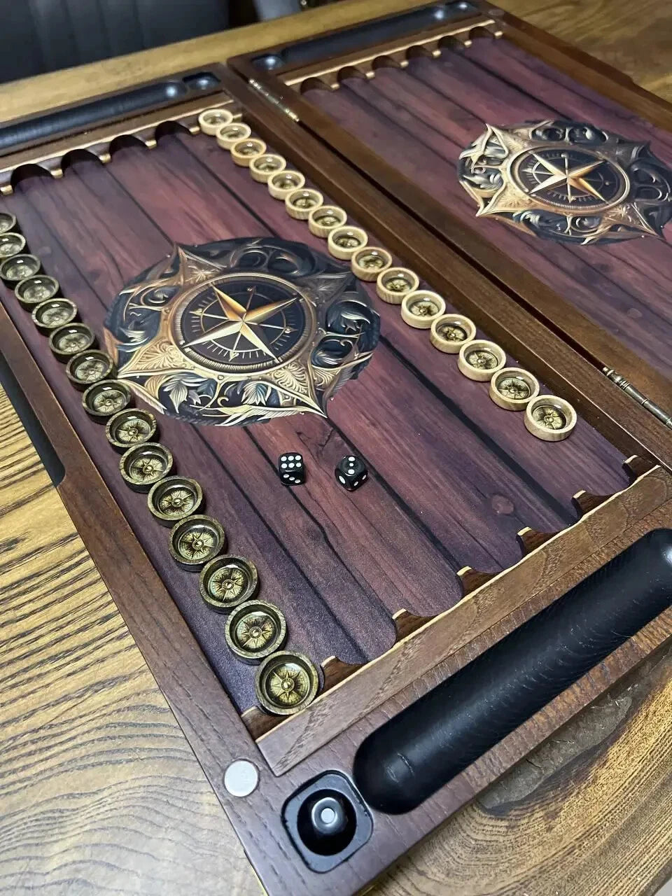 Close-up of wooden backgammon chips with compass design, epoxy resin surface, dice and detailed craftsmanship