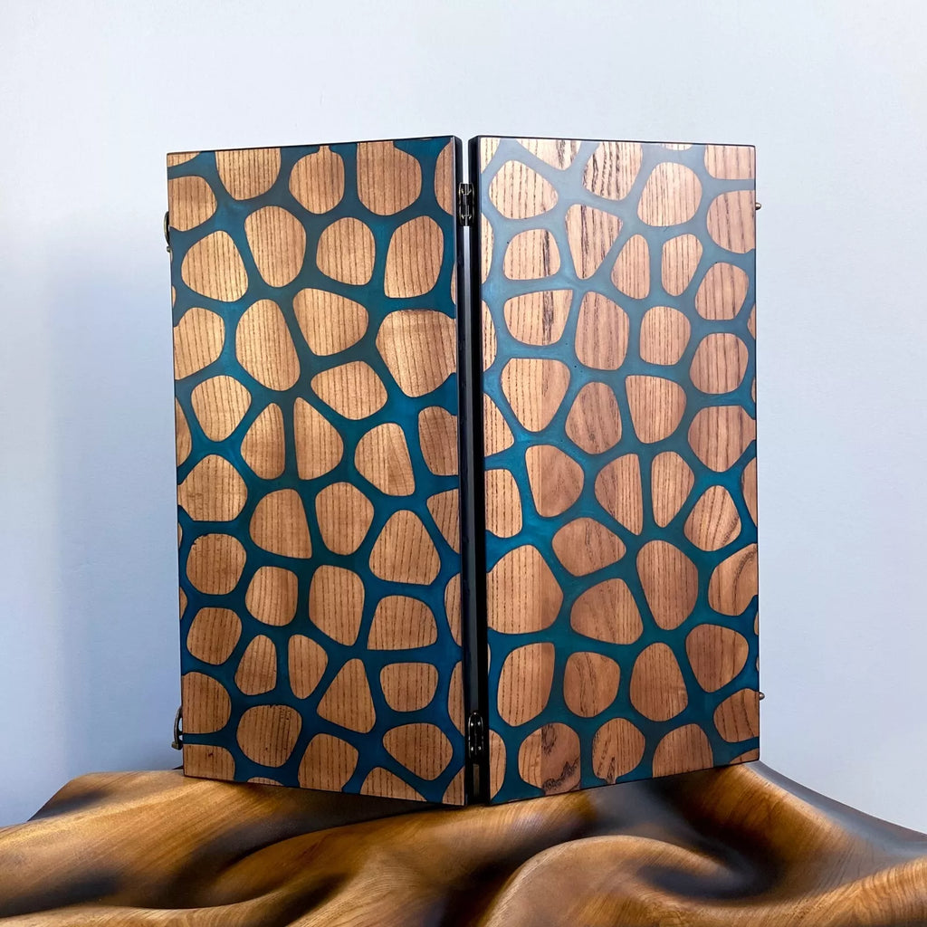 Handcrafted wooden backgammon board with abstract giraffe-pattern resin inlay in blue and natural wood tones.
