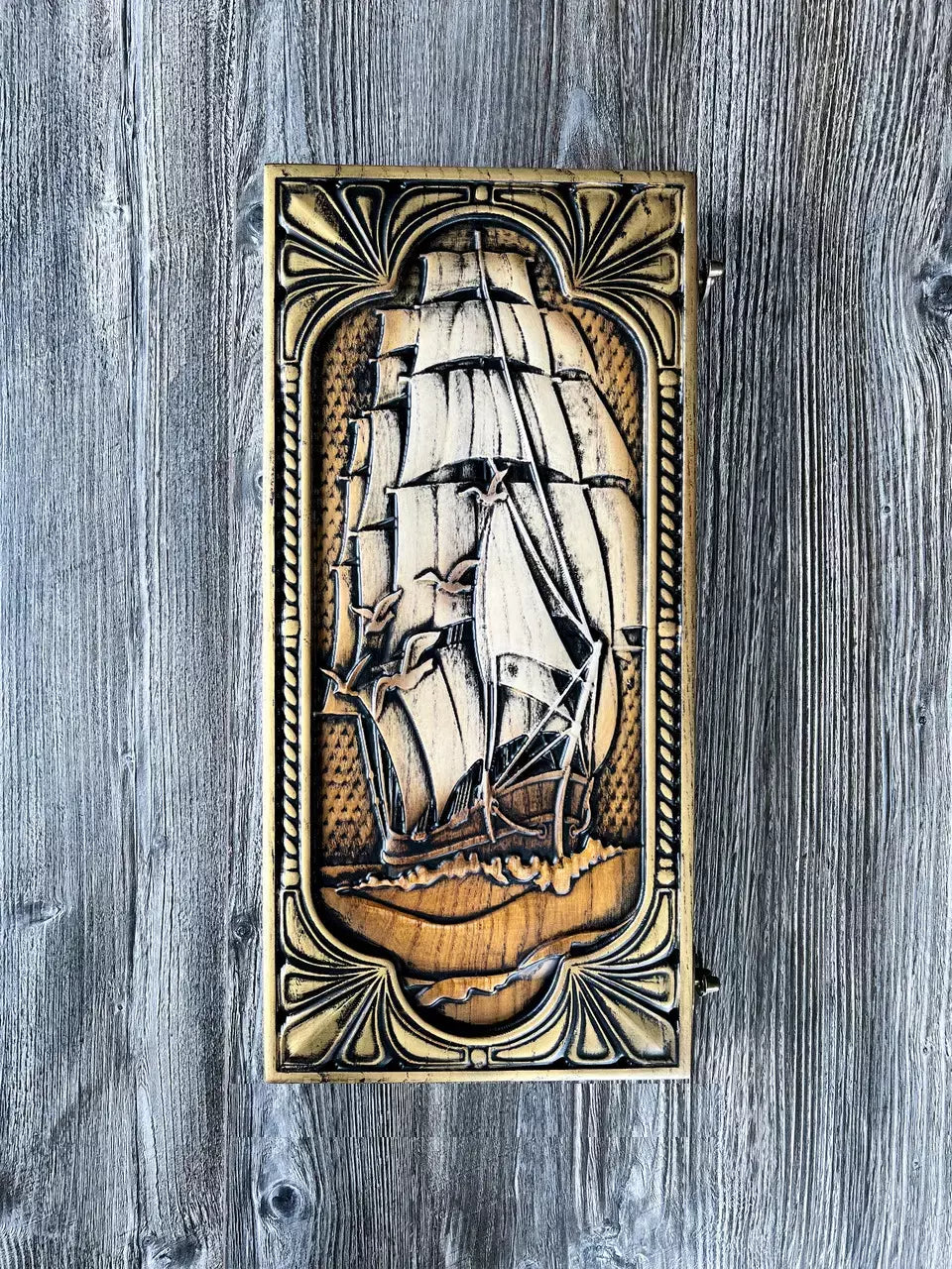 Carved wooden backgammon set featuring detailed ship engraving on the lid.
