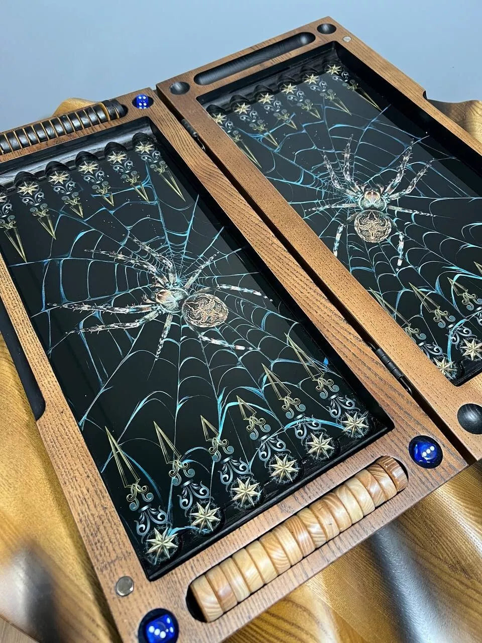 Handcrafted wooden backgammon set interior with spider web artwork, premium board game with playing pieces