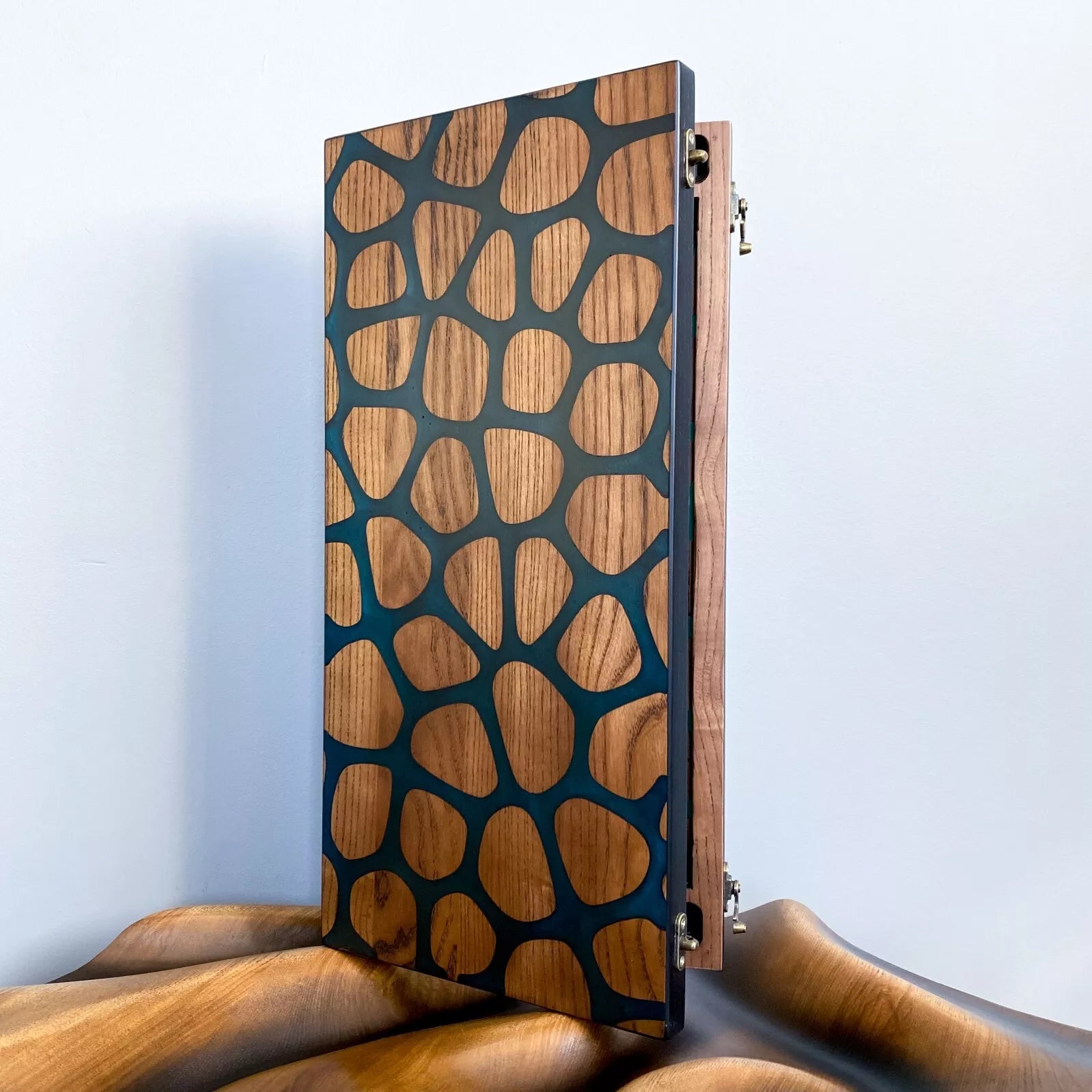 Side view of handmade backgammon board with natural wood mosaic pattern