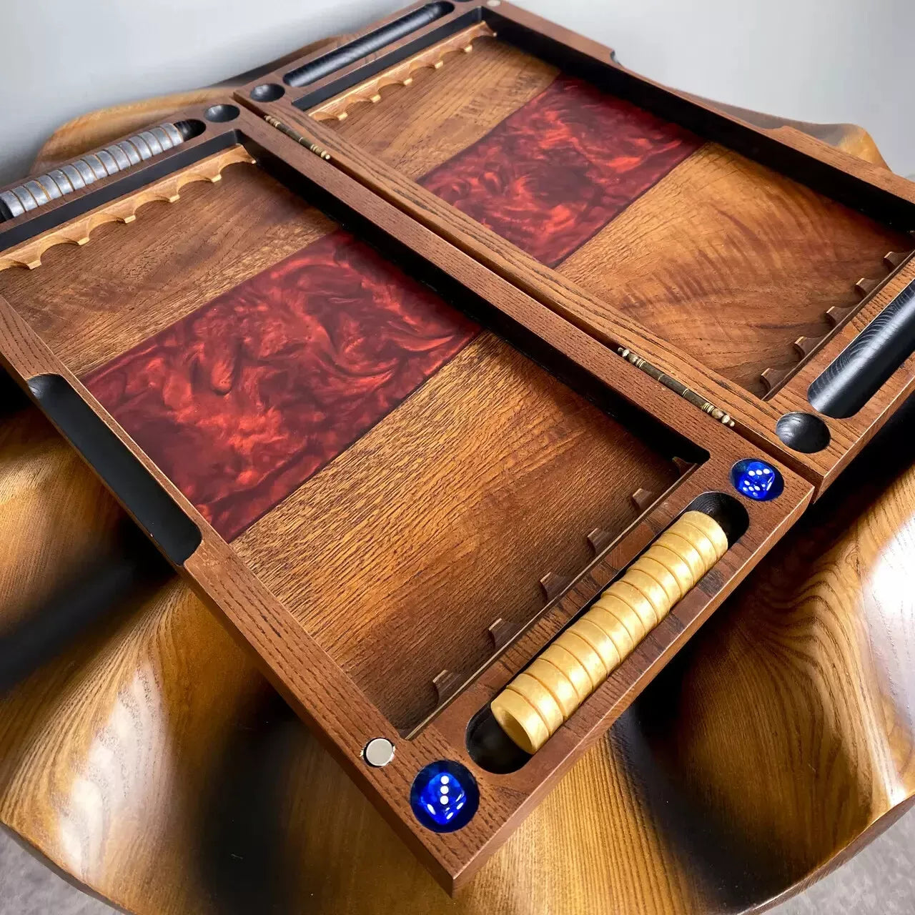 Handcrafted wooden backgammon board with red epoxy resin design and classic playing pieces