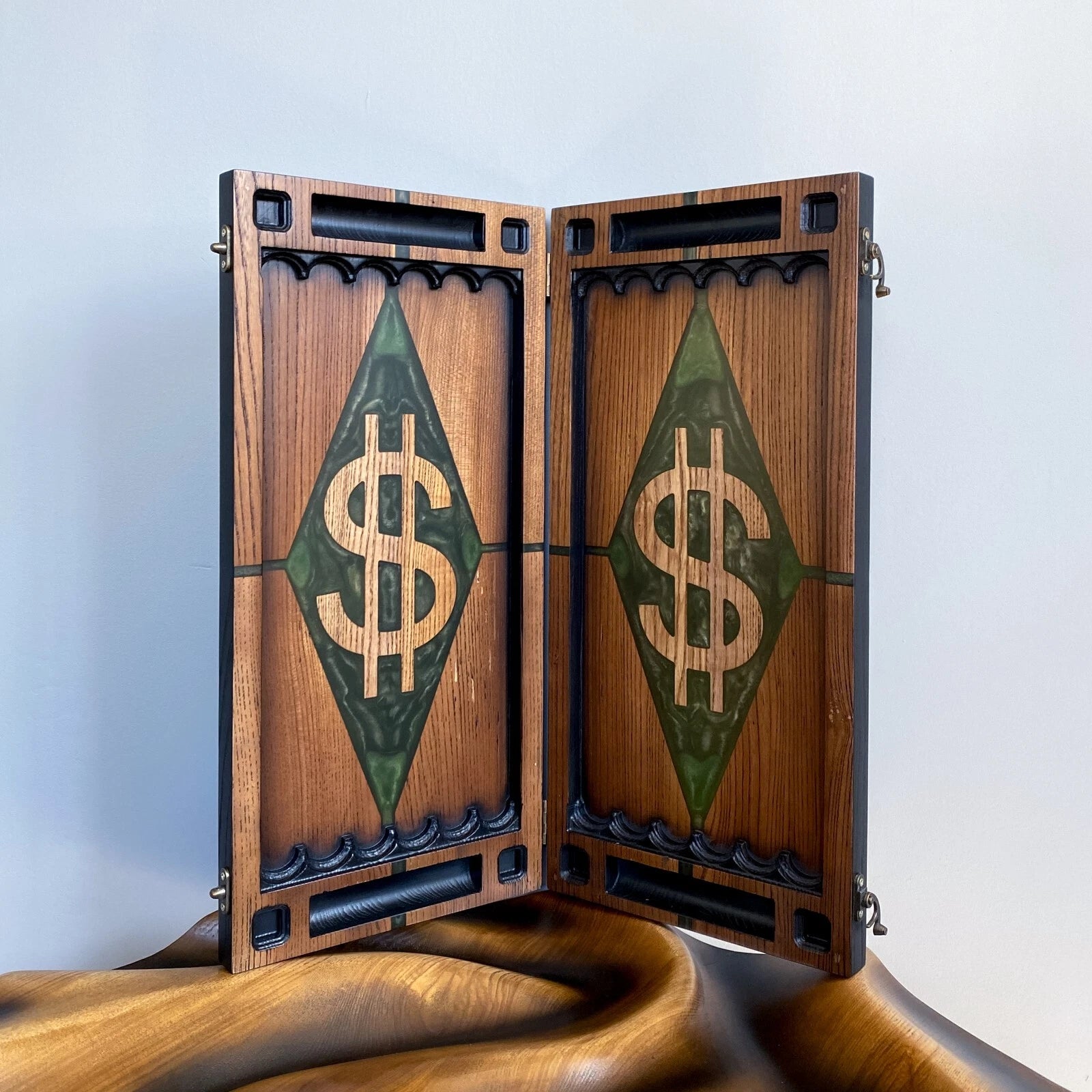 Open wooden backgammon board with a green resin diamond and carved dollar symbol design.
