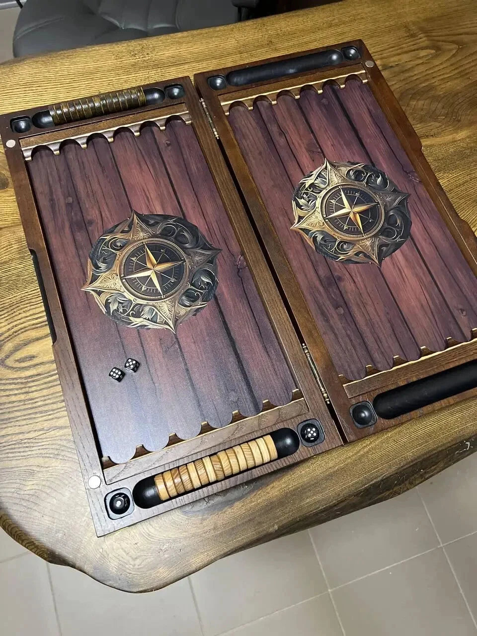 Handcrafted wooden backgammon set with compass rose design, dark wood playing field, epoxy-coated surface, dice and chips included