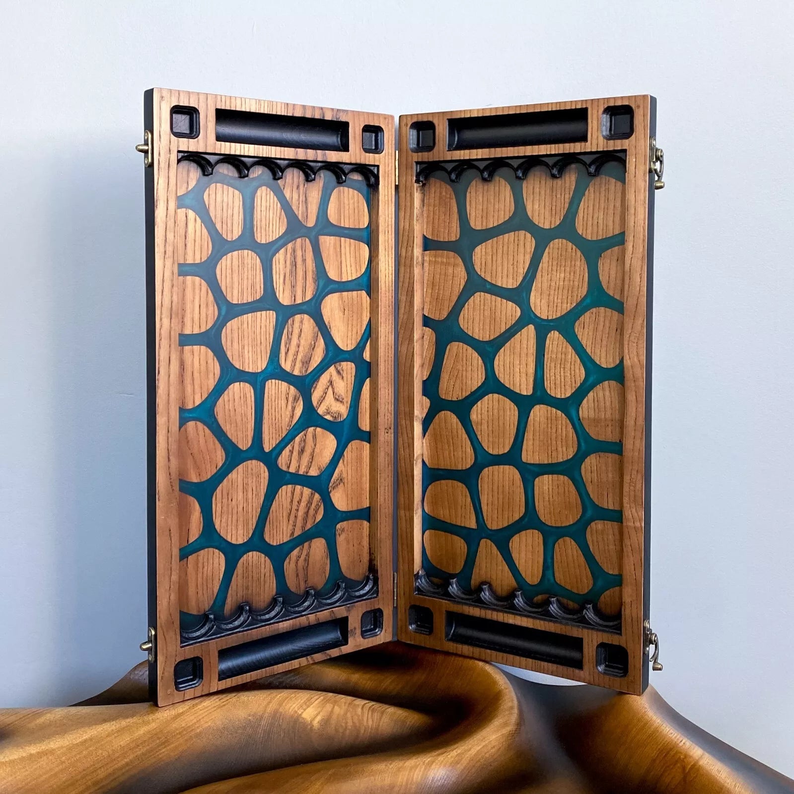 Artistic modern backgammon board with abstract resin shapes and carved details