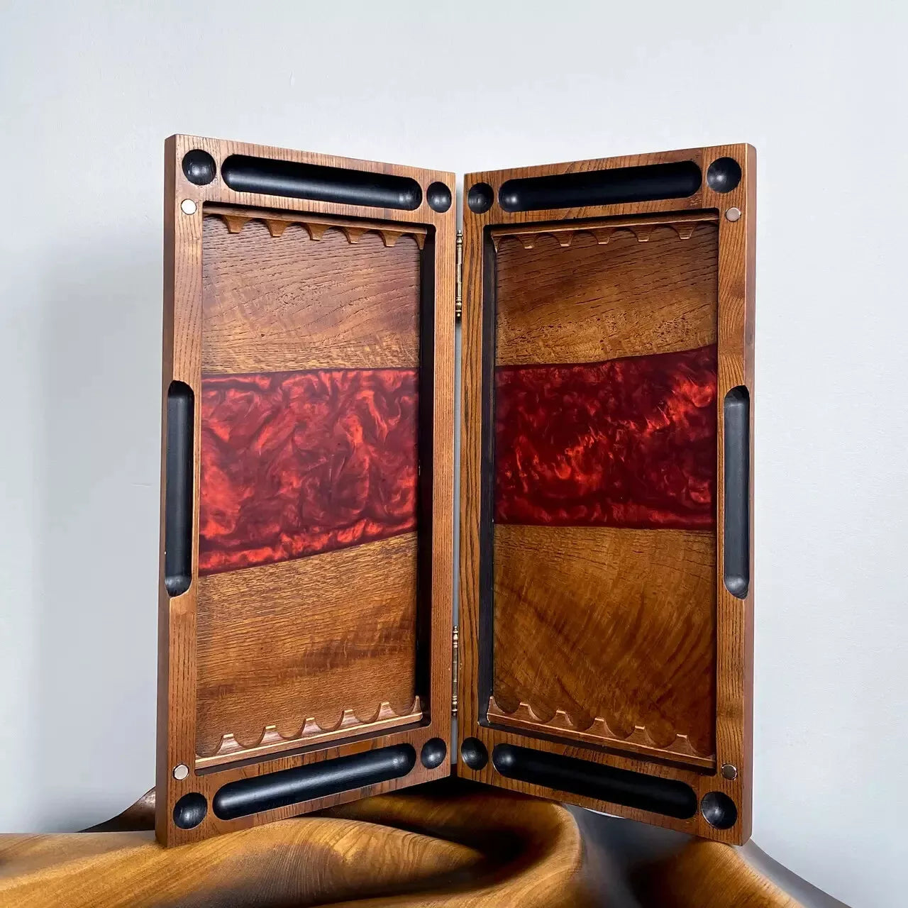 Handcrafted wooden backgammon board opened, natural wood interior with red epoxy resin center stripe