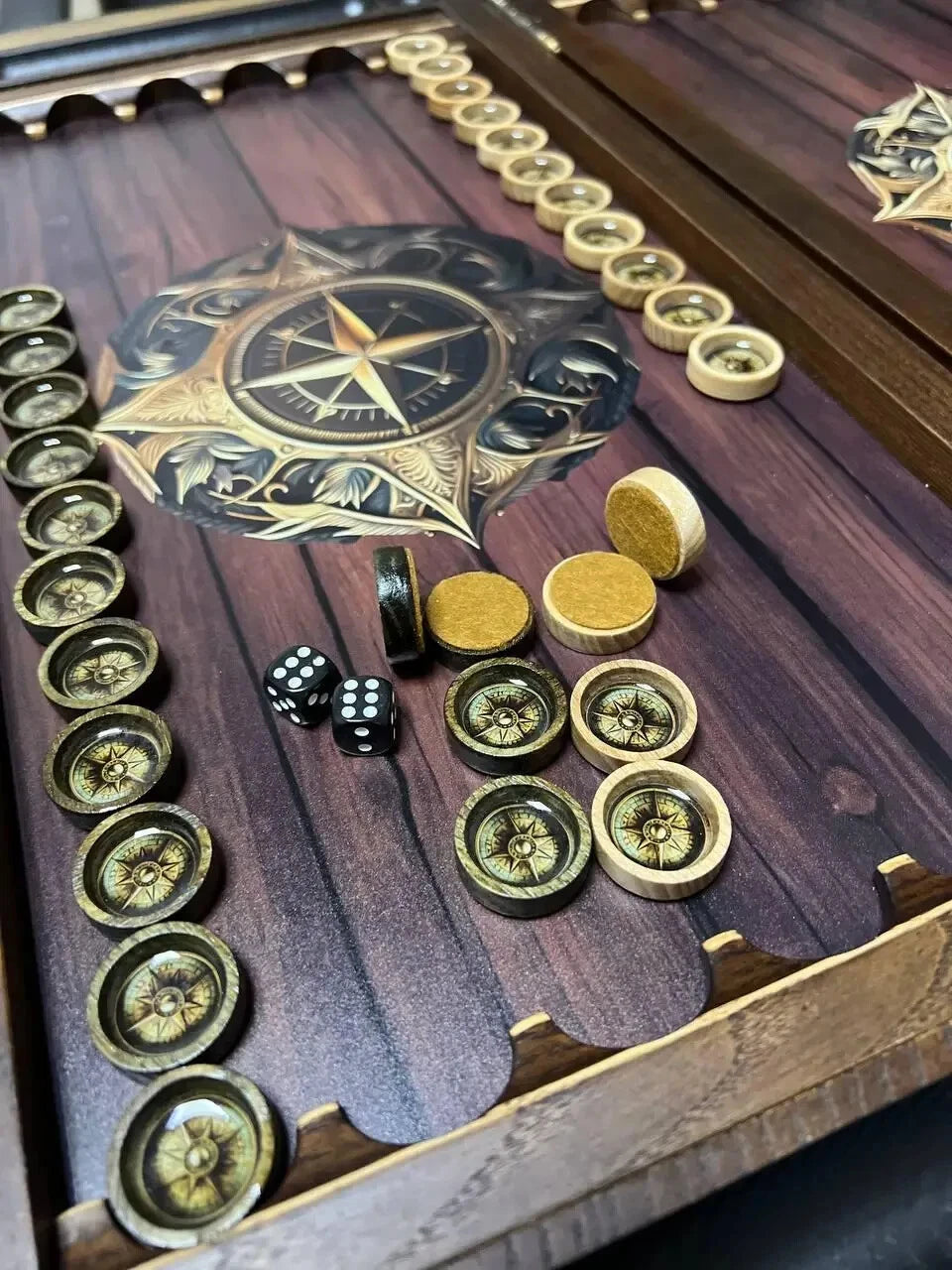 Premium backgammon set interior with compass rose artwork, wooden frame and decorative game pieces