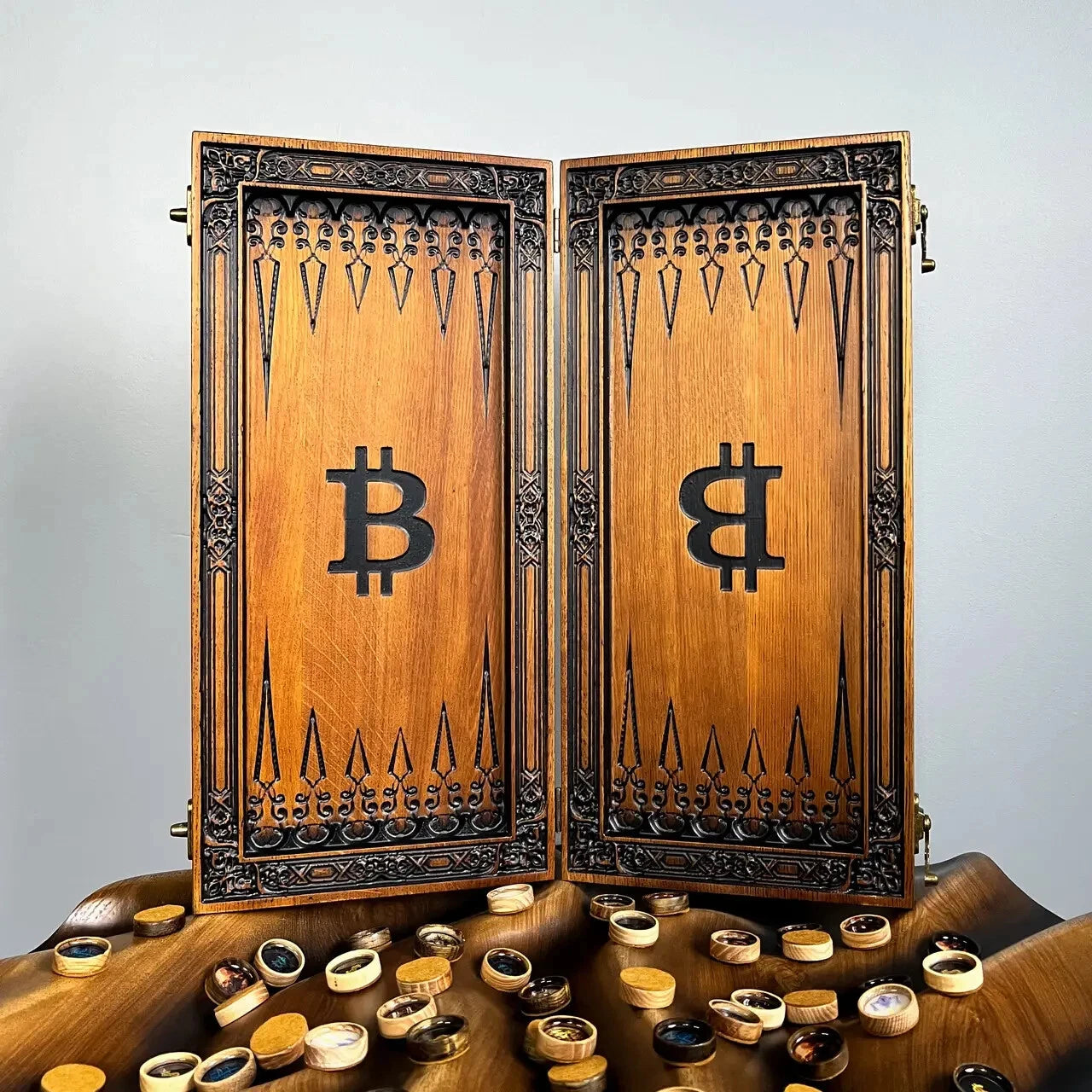 Open wooden backgammon board with Bitcoin symbols inside, handcrafted luxury game set