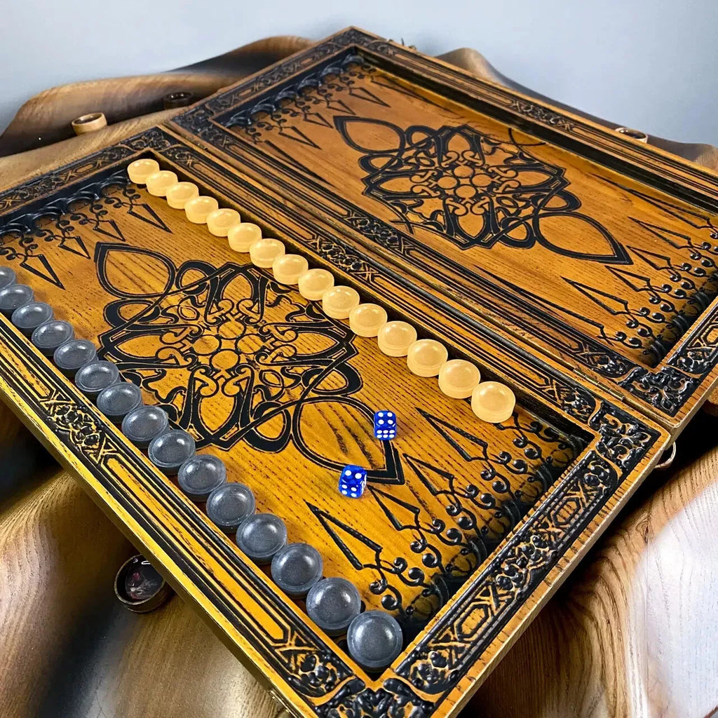 Handmade backgammon set showcasing an engraved geometric pattern with yellow and gray checkers on the playing field.