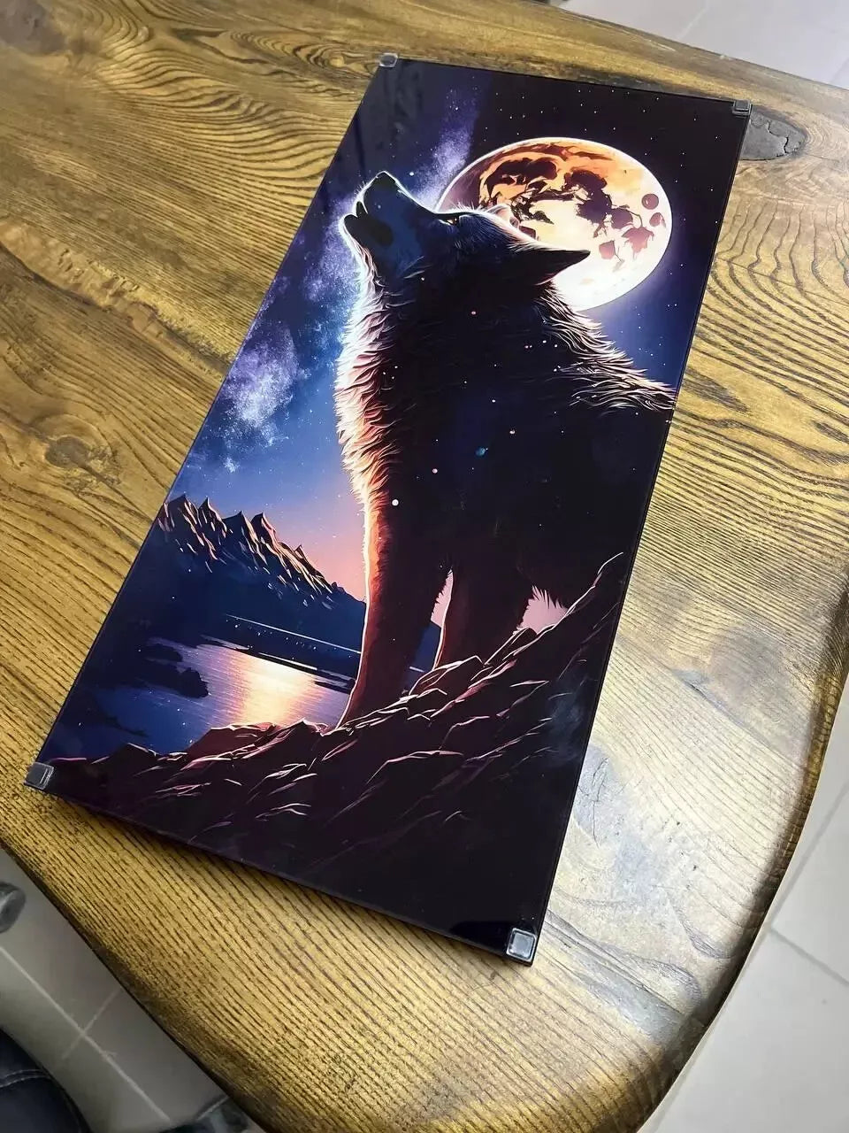 Back view of handcrafted wooden backgammon board with dramatic wolf howling at the moon illustration on the exterior panel