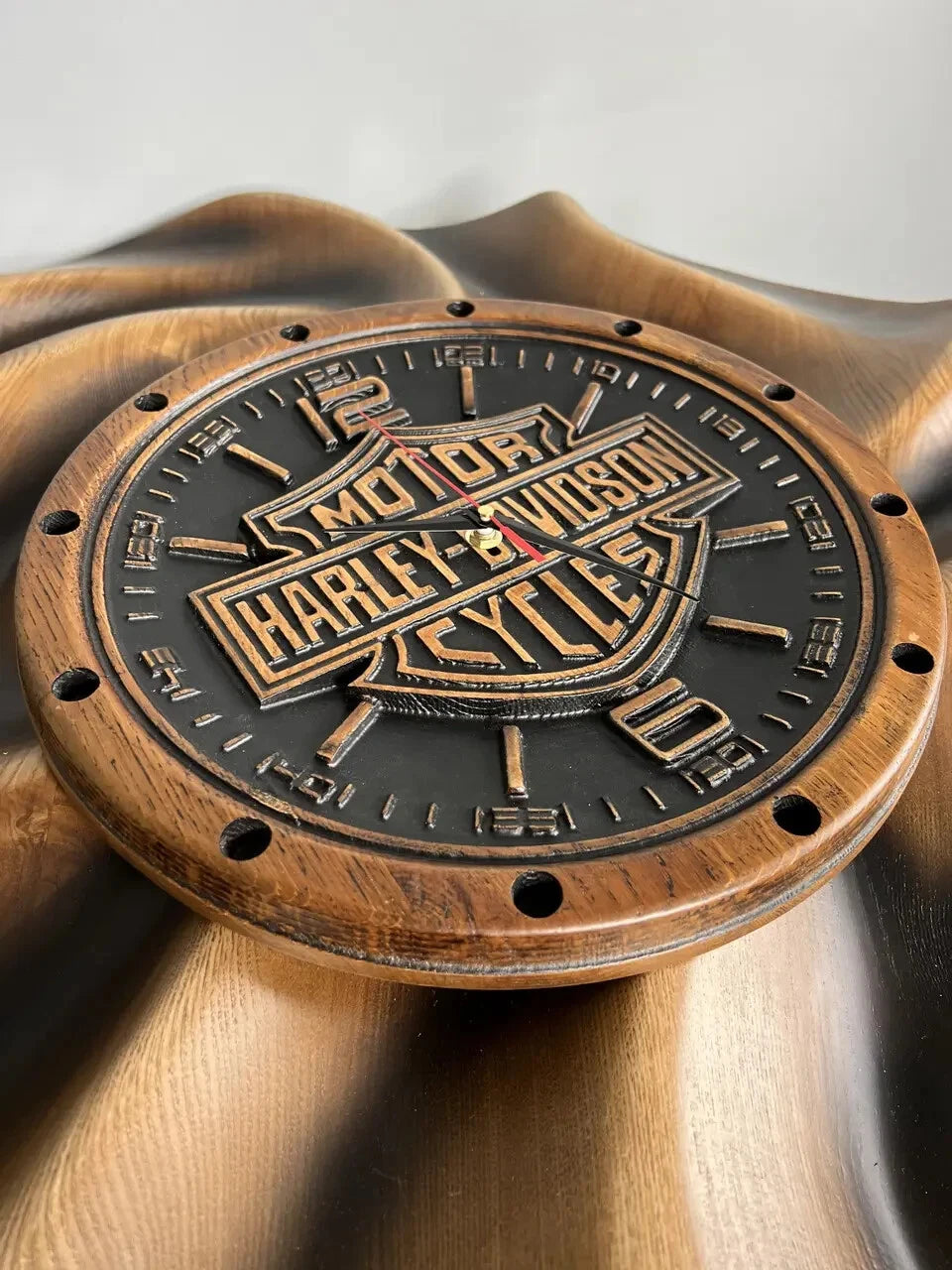 Angled view of handmade wooden wall clock with motorcycle emblem carving, rustic biker style home decor