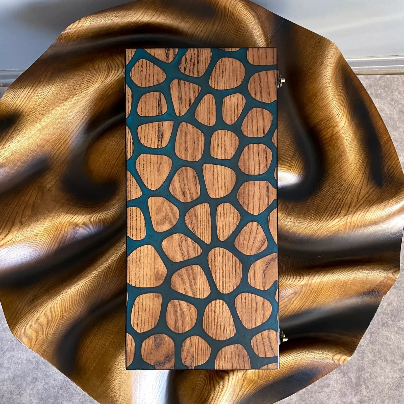 Artistic backgammon board featuring organic stone-style inlay design in wood and dark resin