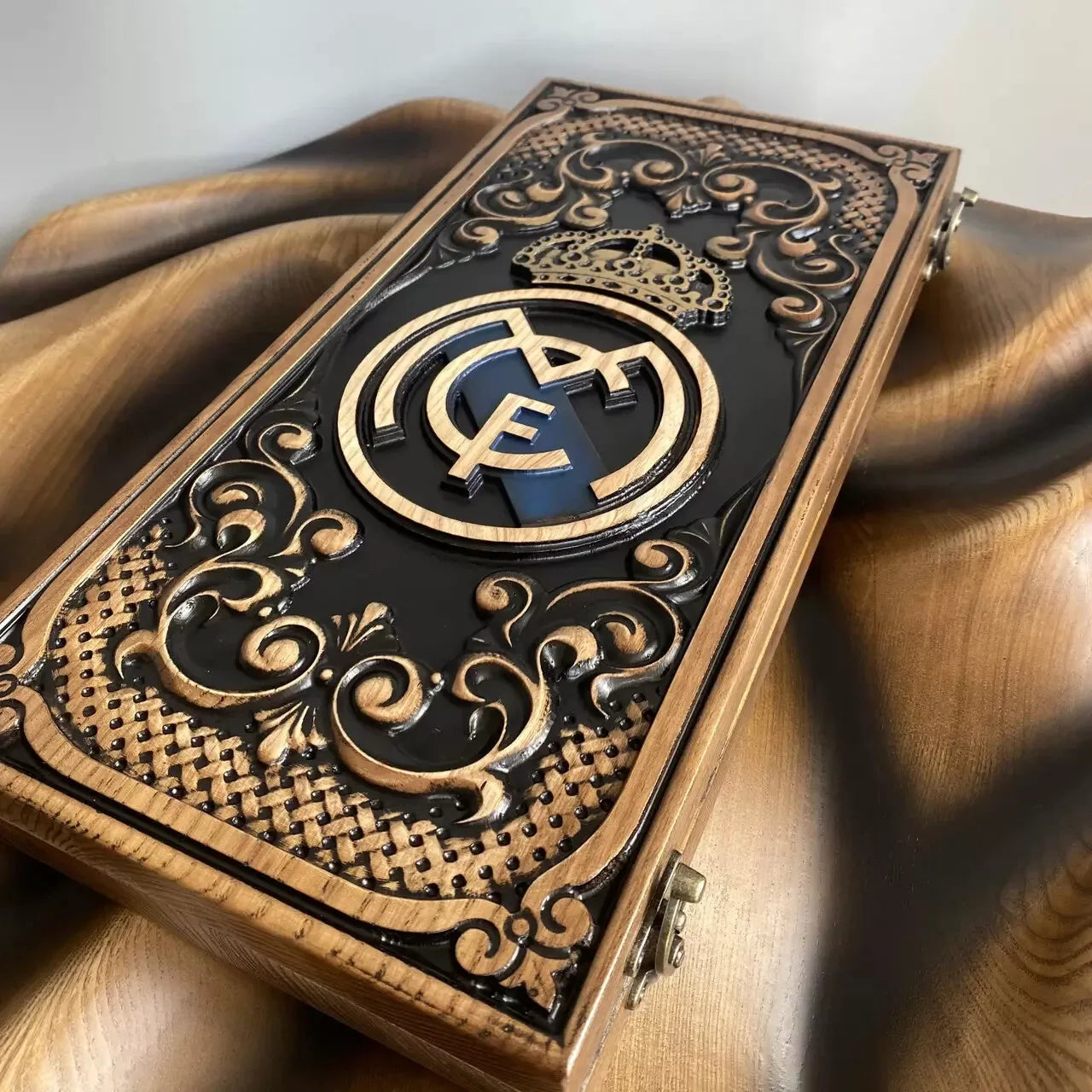 Carved wooden backgammon case showcasing a royal-style emblem and ornate decorative frame.